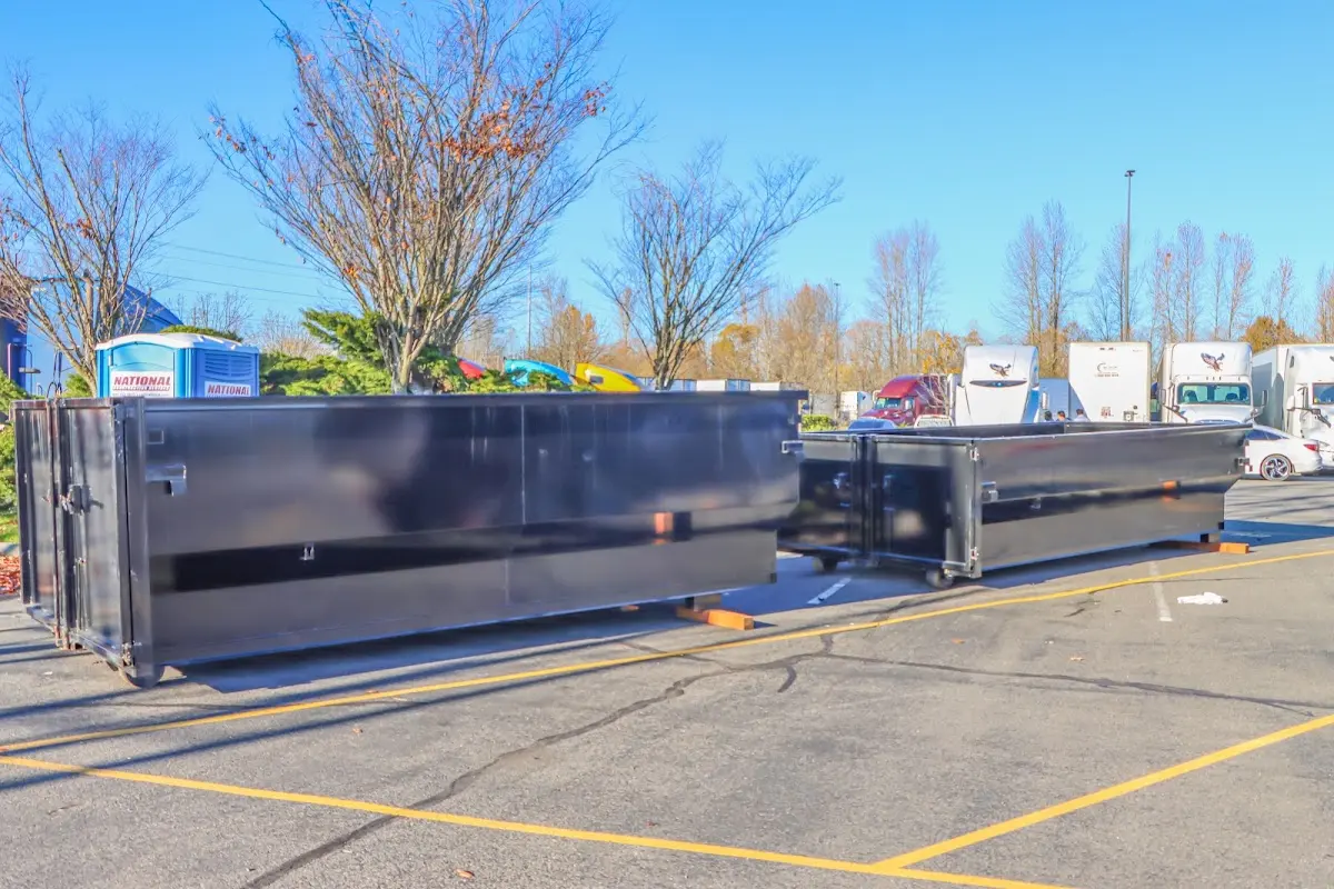Professional dumpster rental service with roll-off container on residential driveway in Picayune
